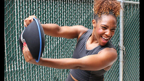 A lady exercising with a sandbell