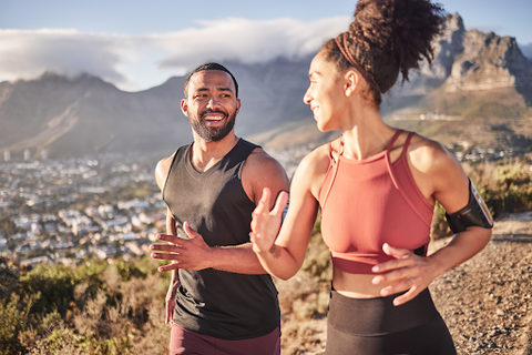 man and woman running together outdoors