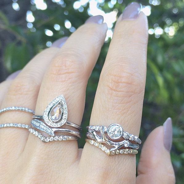 handcrafted white gold and diamond rings on model's hand 