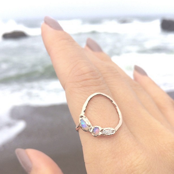handcrafted ring on model's hand by the beach