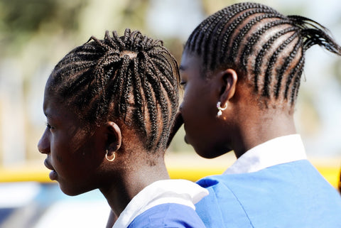 Two young people with cornrow braids.