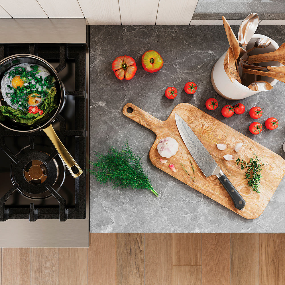 Ceramic frying pan and Japanese Damascus chef knife in a modern kitchen from above