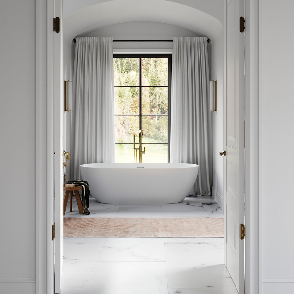 Bathtub with a polished gold bathtub filler in a luxury home