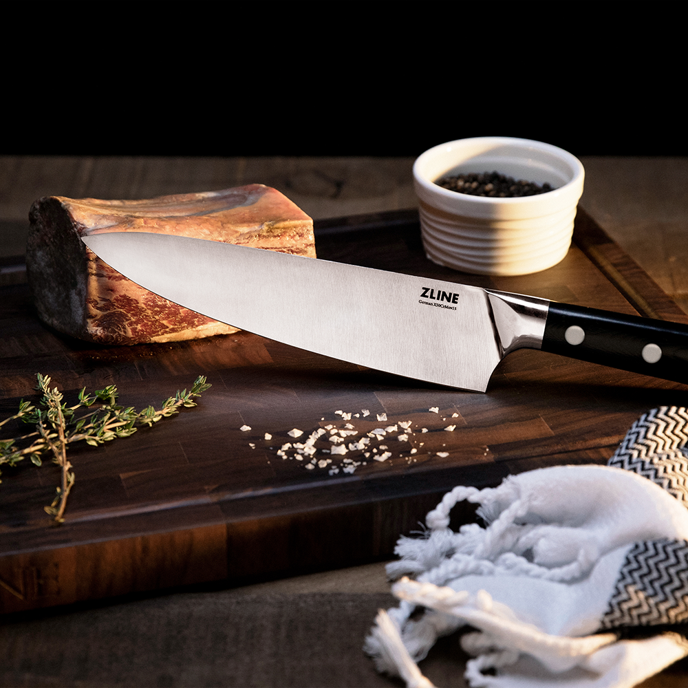 ZLINE German steel chef knife on a cutting board with seasonings
