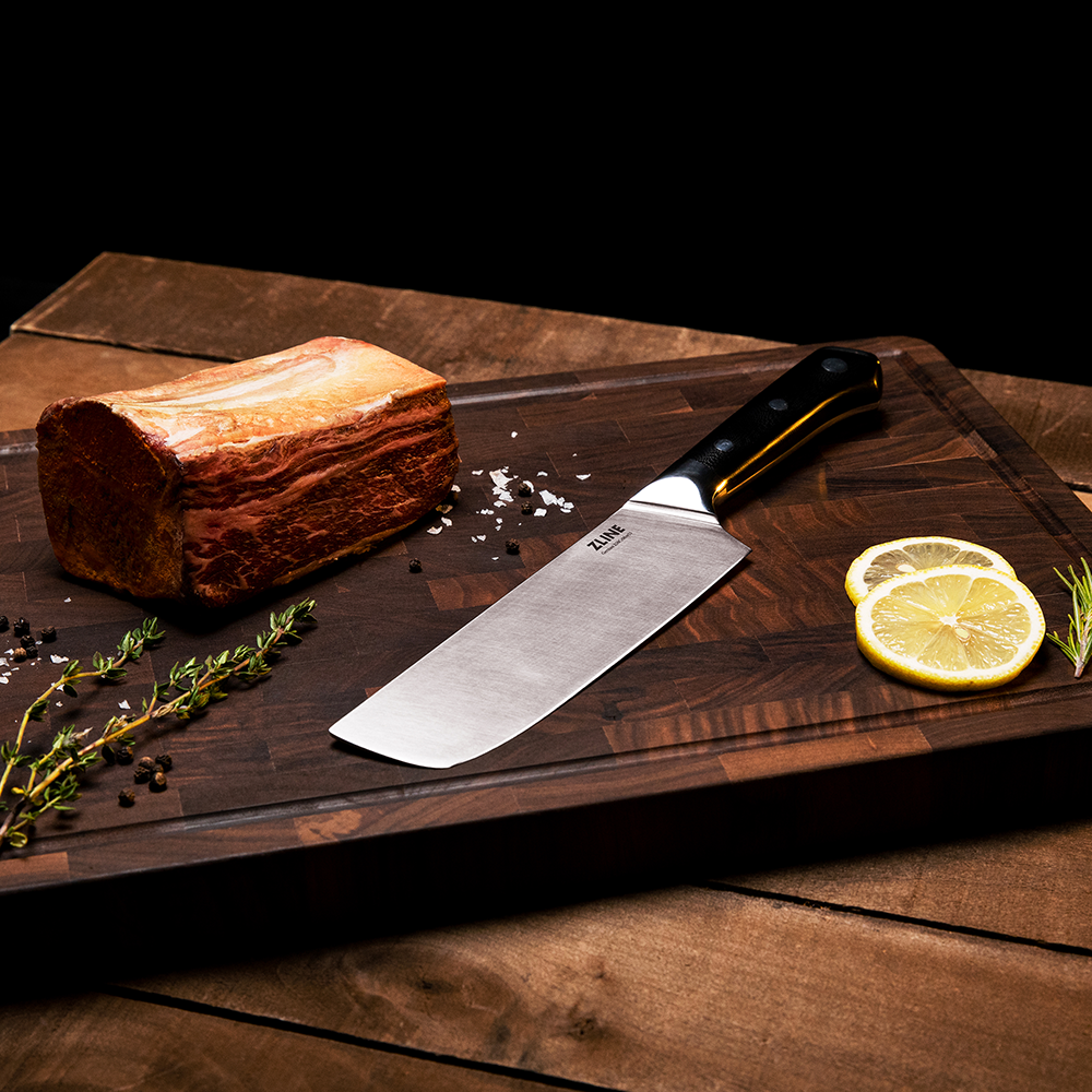 ZLINE German steel 9-inch slicing knife on a cutting board with garnishes
