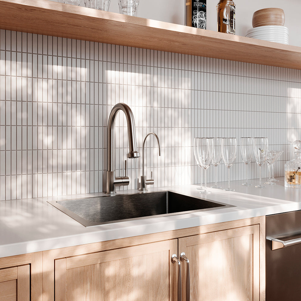 Chrome kitchen faucet in a home bar