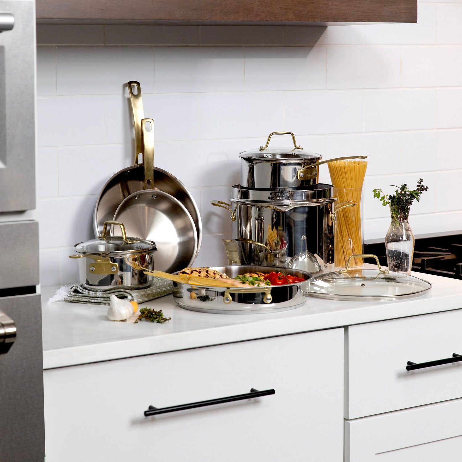 ZLINE stainless steel cookware set on a countertop with food