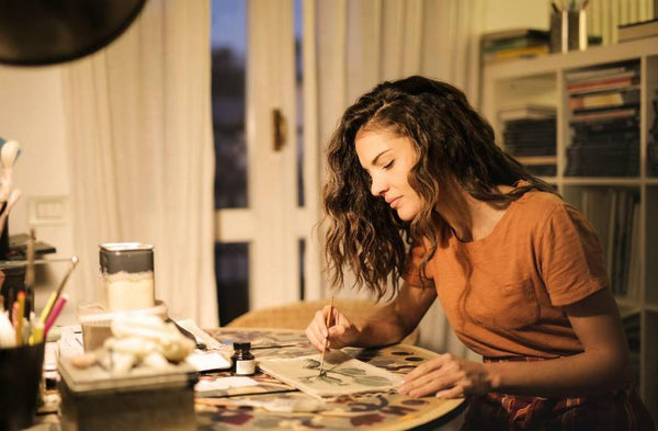 A woman being creative and painting