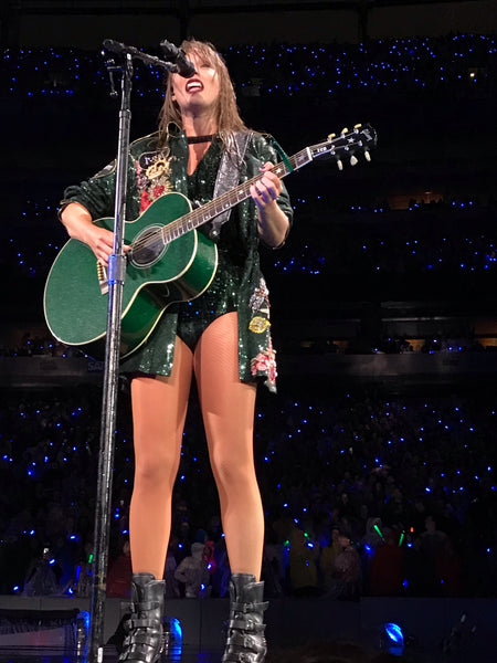 Taylor Swift performing with a guitar