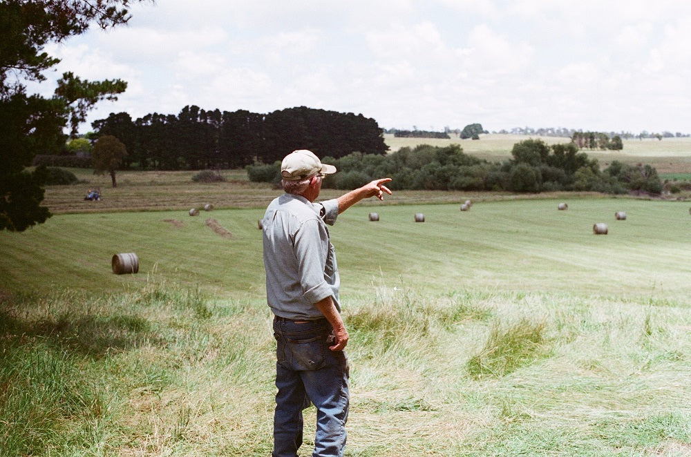 Farmer pointing at his field.