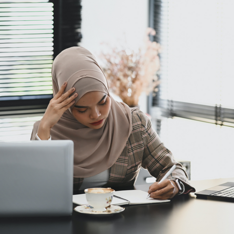 hijab, woman, laptop, tired, stressed, muslim woman, magnesium oil spray, magnesium deficiency 