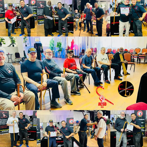 This collage shows participants in an ACSD event posing with certificates, holding canes, or sitting in a group. Many wear ACSD-branded shirts, and some are receiving awards. A red "ACSD USA" logo is featured centrally, with banners in the background promoting cane self-defense programs.