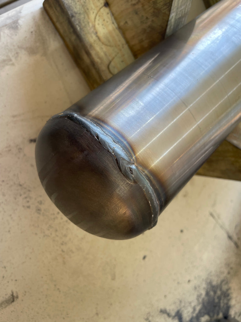 Steel dome caps welded to the ends of the pipe.