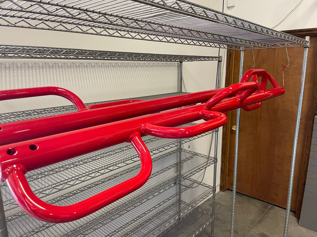 Twister bar main assemblies after powder coating primer, color, and clear coat. Top-notch work from Top Dog Powder Coating!