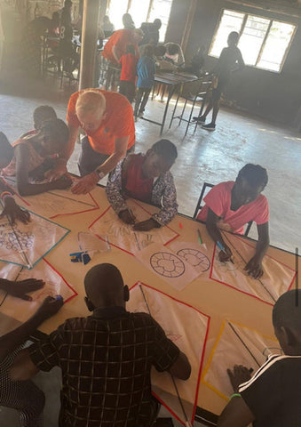 Children having fun tracing images onto their own kites