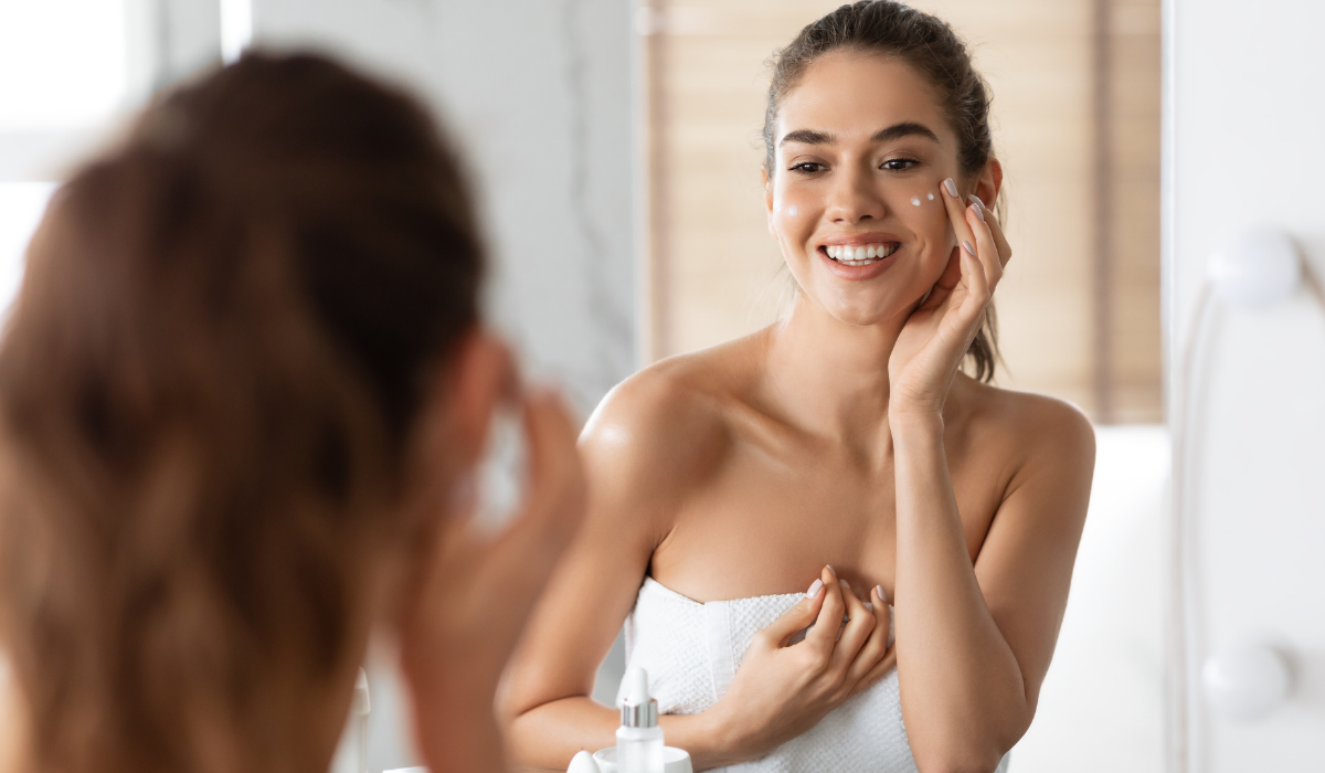 female-caring-for-skin-moisturizing-face-with-crea