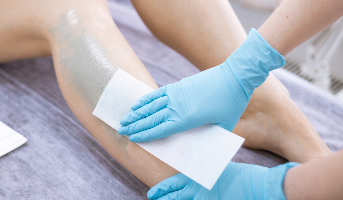 female-legs-hair-removal-with-wax-in-beauty-salon