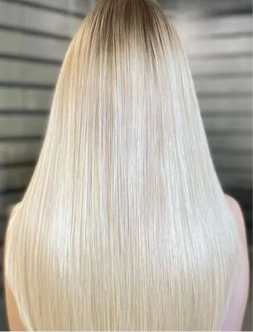 Blonde hair with dark roots, smooth and straightened.