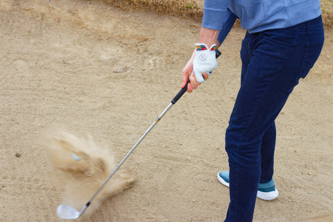 Golfer hitting bunker shot