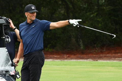 Tom Brady pointing with golf club