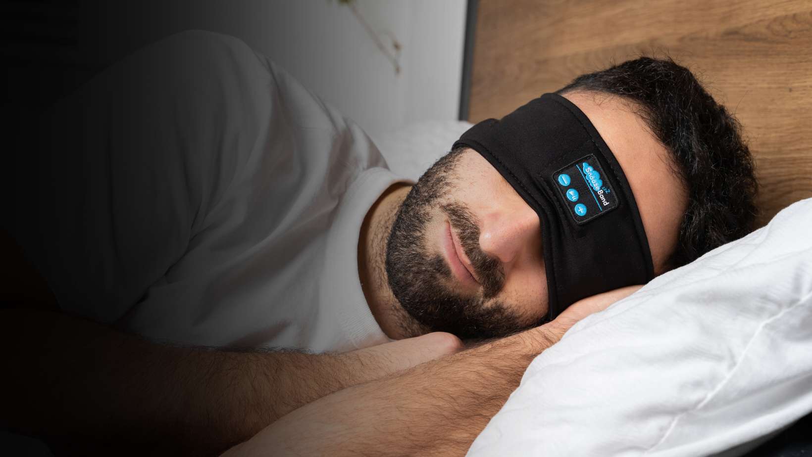 Man sleeping with a high-tech eye mask on.