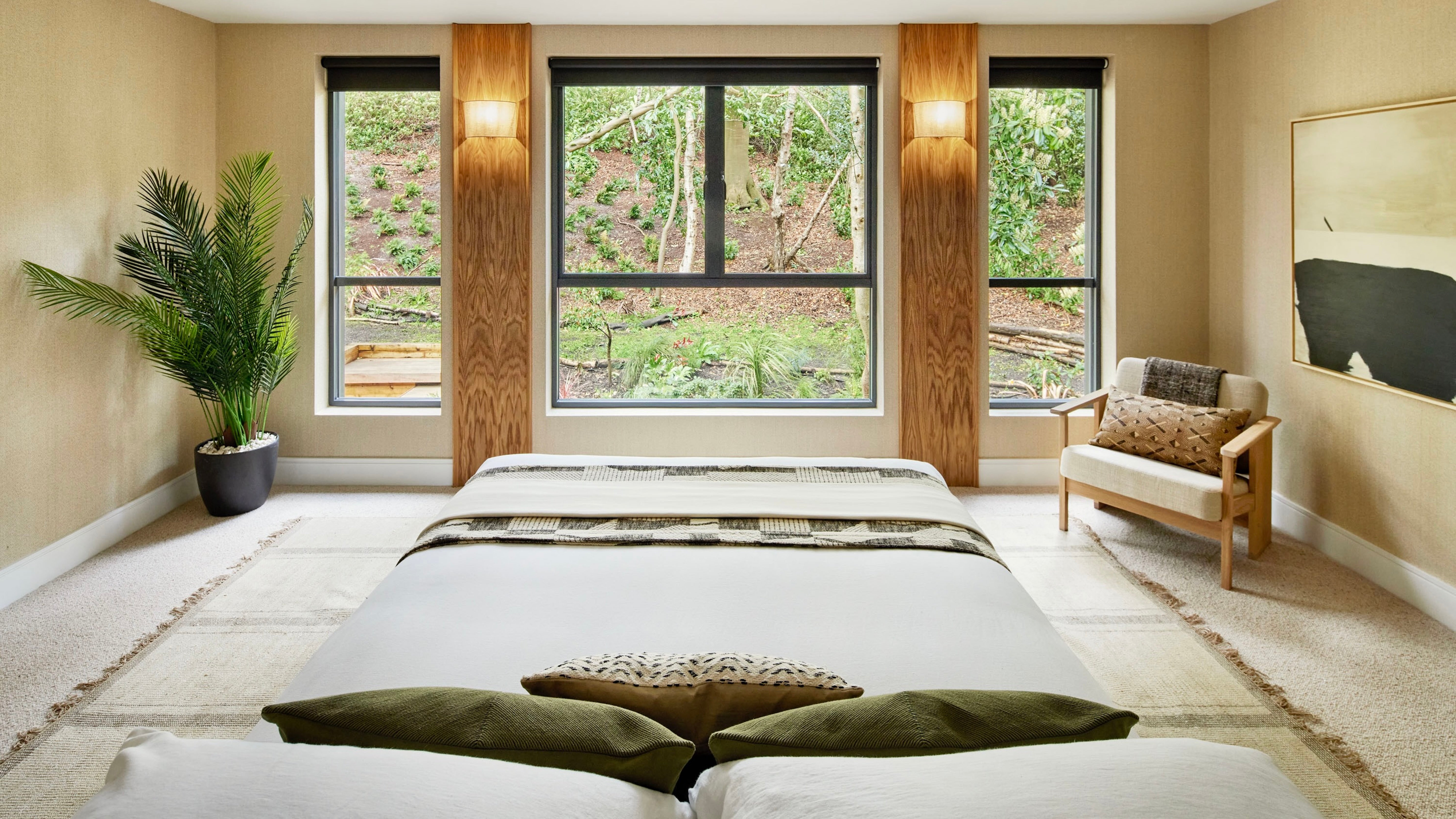 <p><strong>Main Bedroom</strong></p><p>Warming taupe walls, white linen bed sheets and illuminated timber cladding create a comforting main bedroom with its own garden panorama, dressing room and en suite.</p>