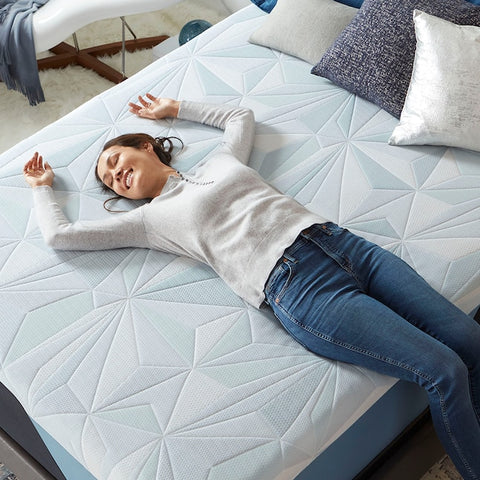 a lady laying on a serta arctic hybrid mattress - Mattress Mars 