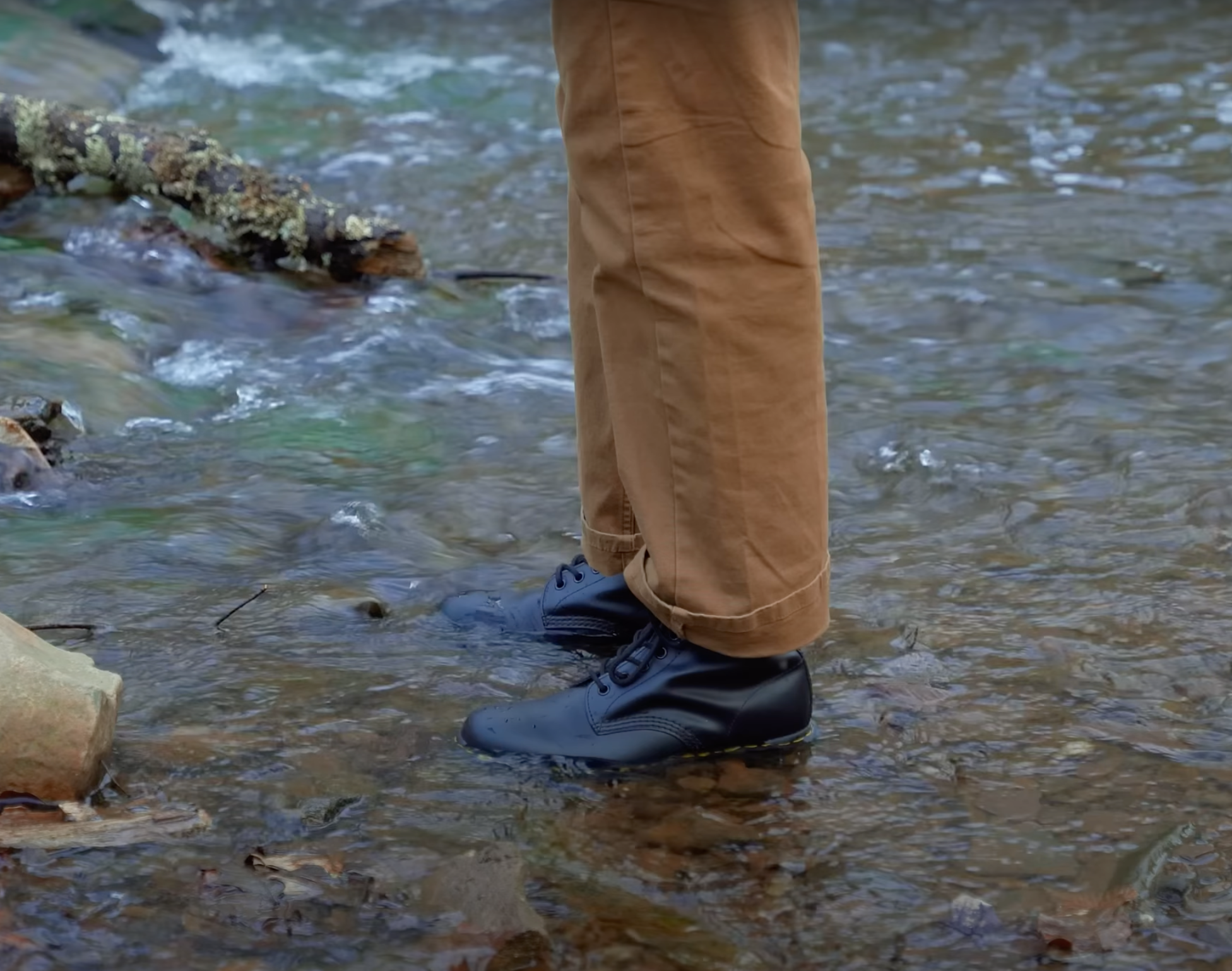 Man standing in river wearing Dr. Martens Black 1460 Boots