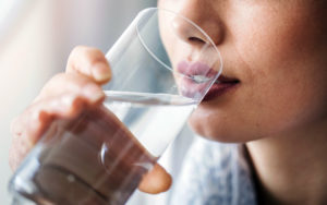 Woman drinking water after working out