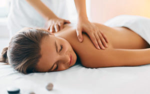 woman getting a massage as a new recovery trend