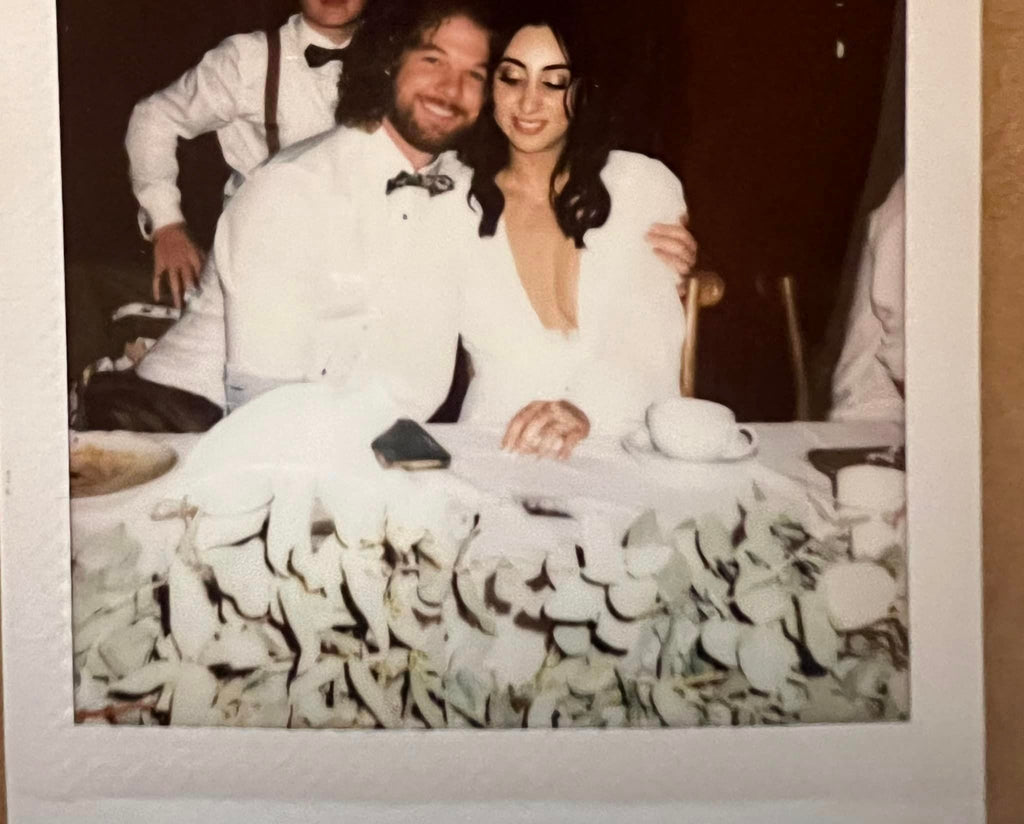 A vintage style polaroid of the newly wed couple at the bridal table.