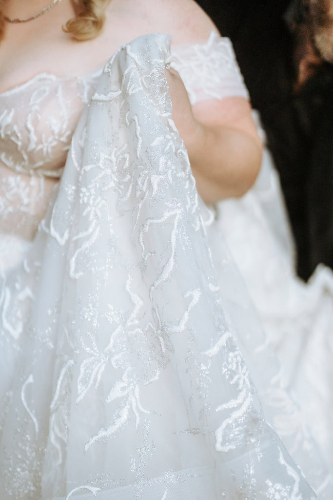 A close up of Chantelle's wedding gown shimmering in the sunlight.