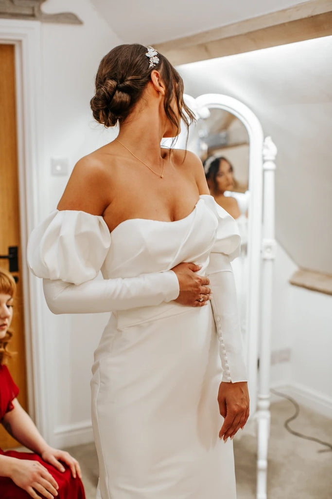 Katie glances over her shoulder to see the reflection of her gorgeous wedding dress in a full-length mirror.