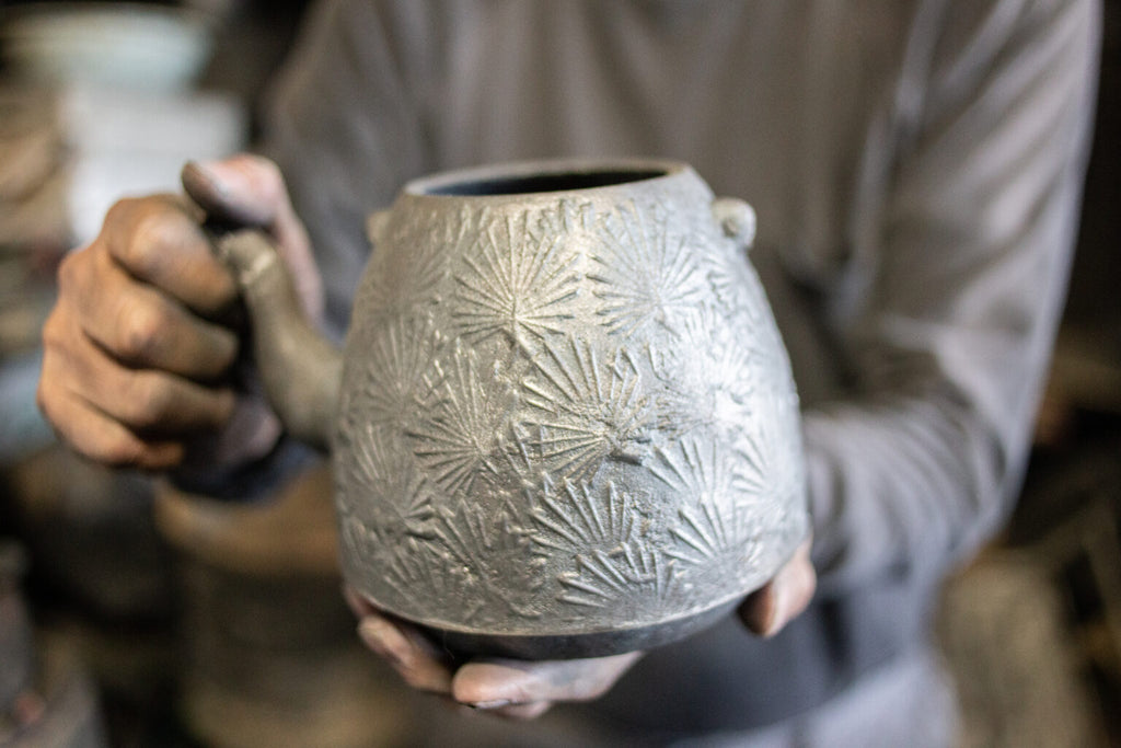 The iron kettle 'NAMBU STYLE SYOUMATSUBA (Pine Needle)' featuring the auspicious pine needle motif boldly arranged, still in the process of production.