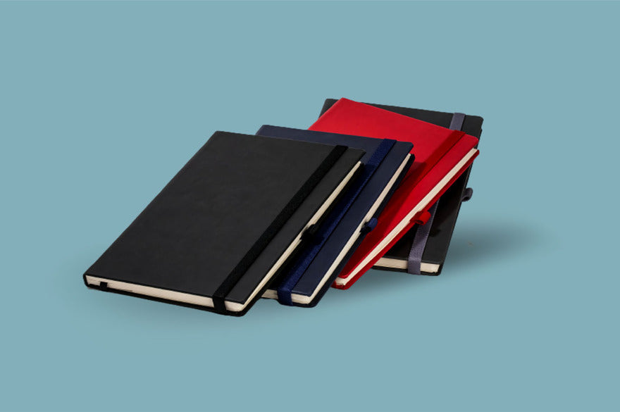Schwarze und rote Notizbücher auf blauem Hintergrund