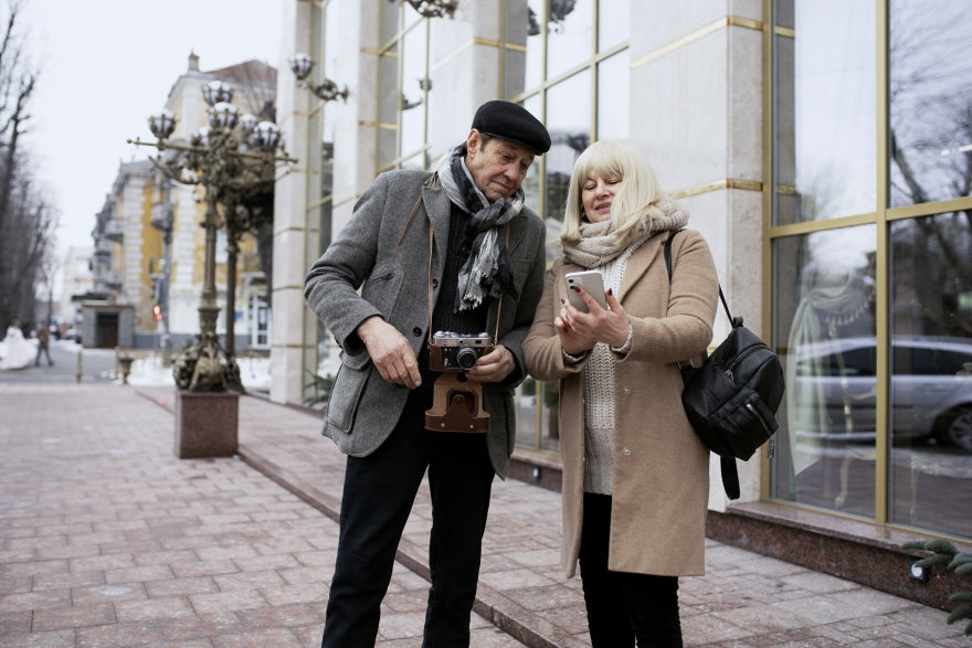 Ältere Paare reisen mit Tasche tragen Handy schauen