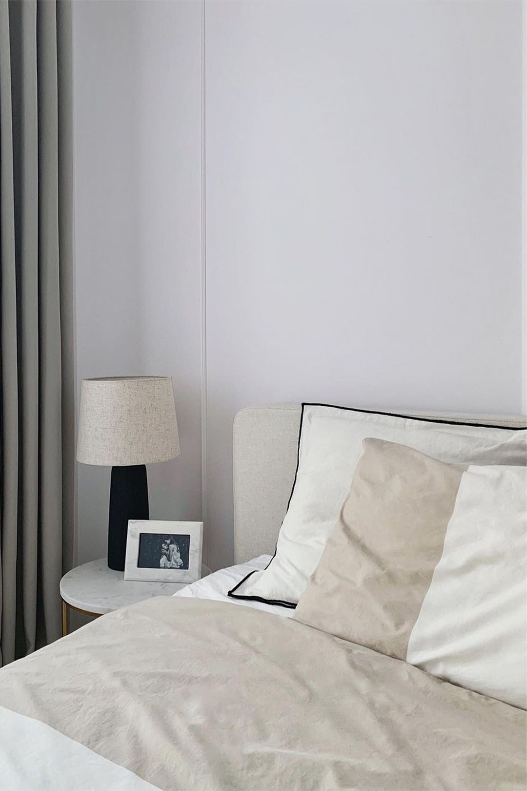 Creamy upholstered bed as a fashionable bedroom arrangement