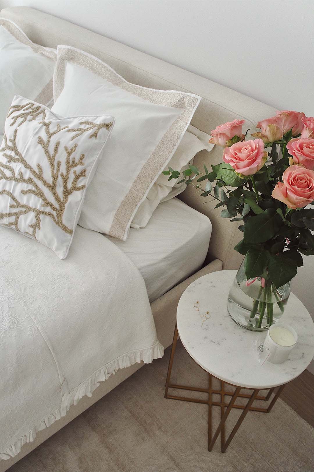 Creamy upholstered bed as a fashionable bedroom arrangement