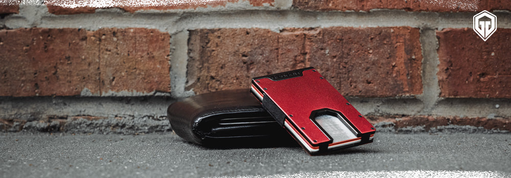 A regular thick leather wallet on the bottom and a Geogrit slim wallet laying on top