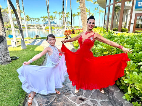 Mother and daughter posing in ballroom dance dresses