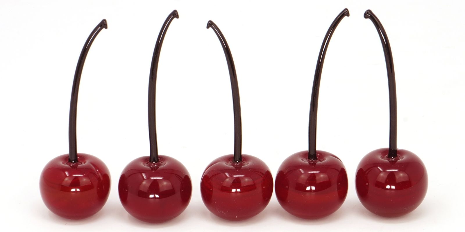 Five Murano Glass Cherries lined up in a row