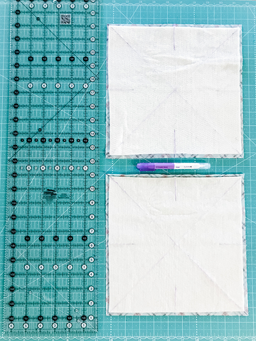 Green cutting mat with a long acrylic ruler, marking pen and two batting squares