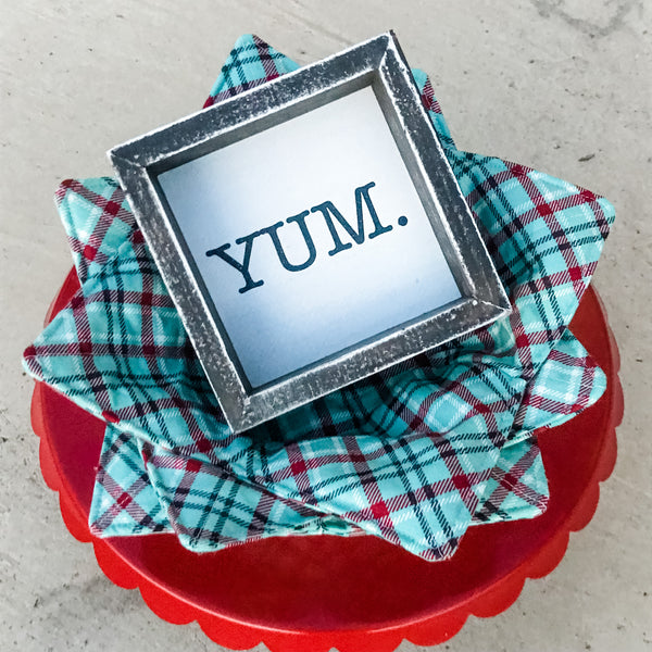 Microwave bowl cozy with a wooden YUM sign on a red cake stand
