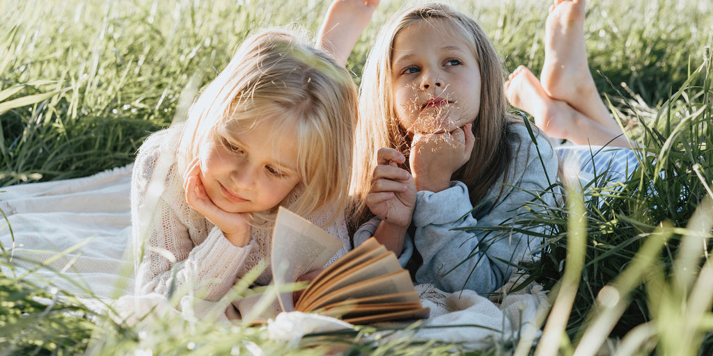 Girls reading in the grass