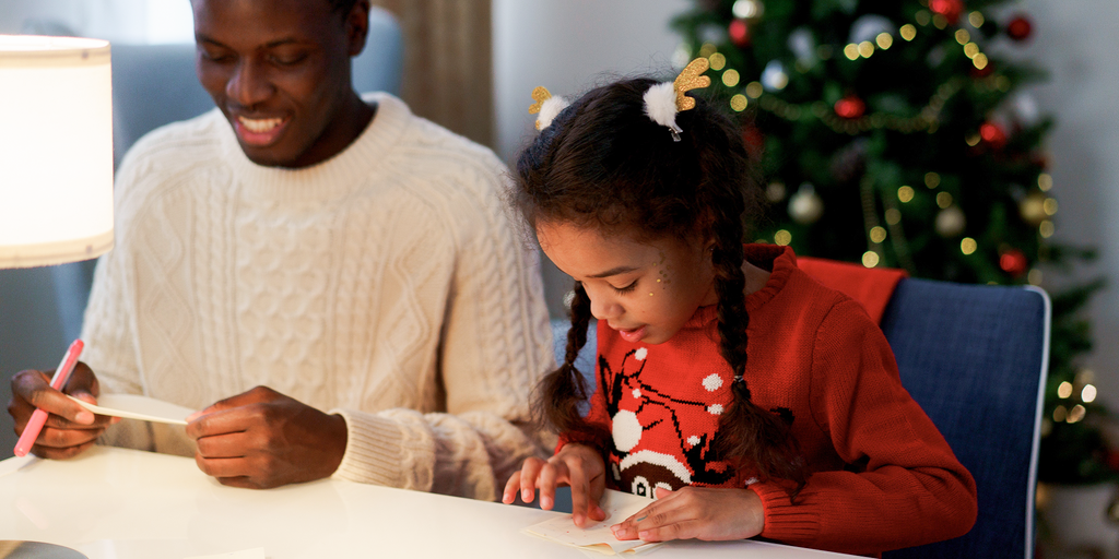 Father and daughter making Christmas crafts