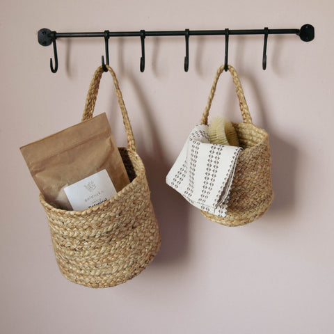 storage baskets hung on hook rail