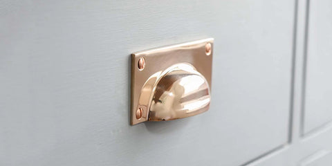 Gun Metal Hooded Drawer Pull on pale drawer