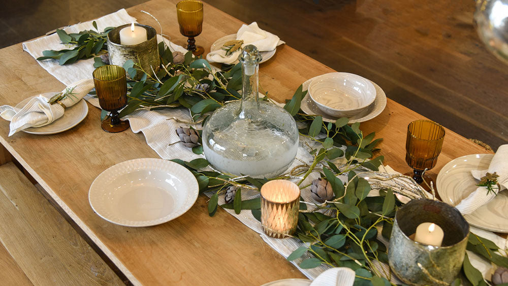 Festive table with foliage and simple neautral crockery