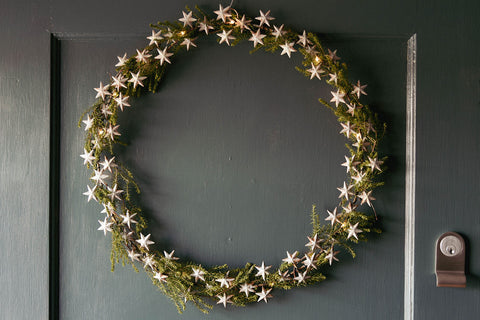 metal star wreath on blue grey front door