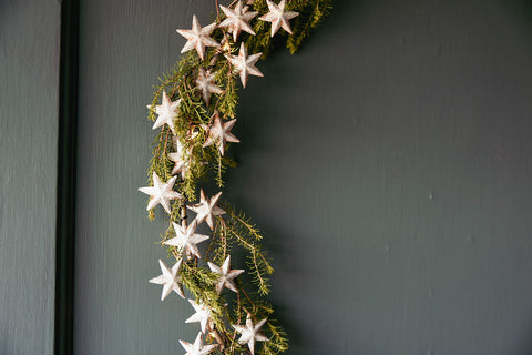 Detail of metal star wreath with foliage